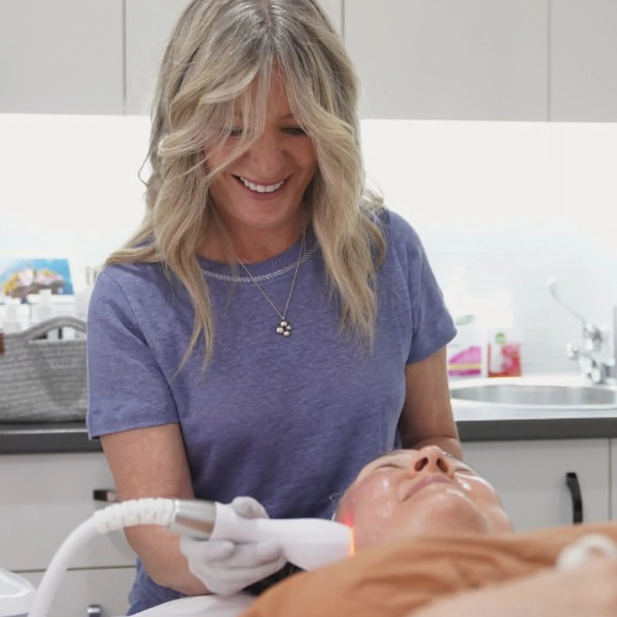 practitioner performing facial laser treatment